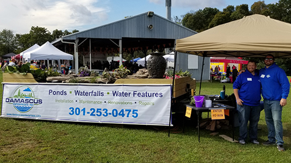 Pond Crew Standing In Front of Pond Trailer Display